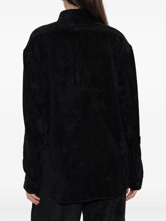 Black shirt worn by a person, showing the shirt's fit