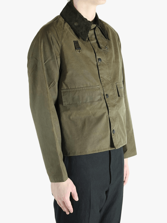 Green jacket worn by a person, showing the jacket fit