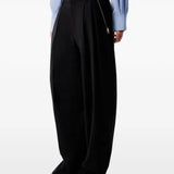 Black pants worn by a person, showing the pants fit