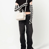 White bag worn by a person, showing the bag's fit