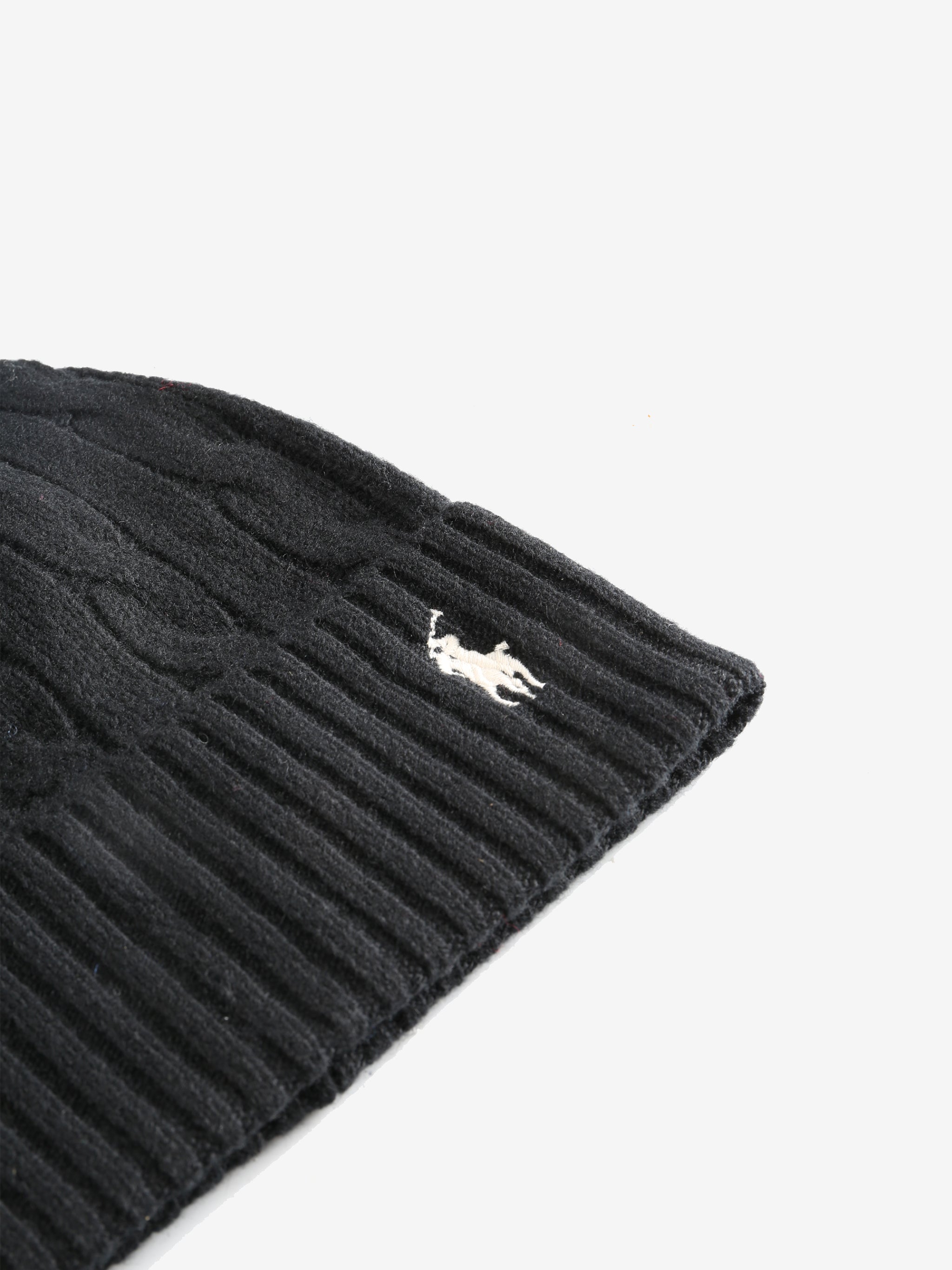 Close up of black hats, showing texture of the cashmere and wool fabric