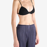 Black bra worn by a person, showing the bra's fit