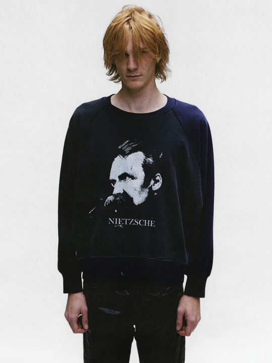 Black sweatshirt worn by a person, showing the sweatshirt's fit