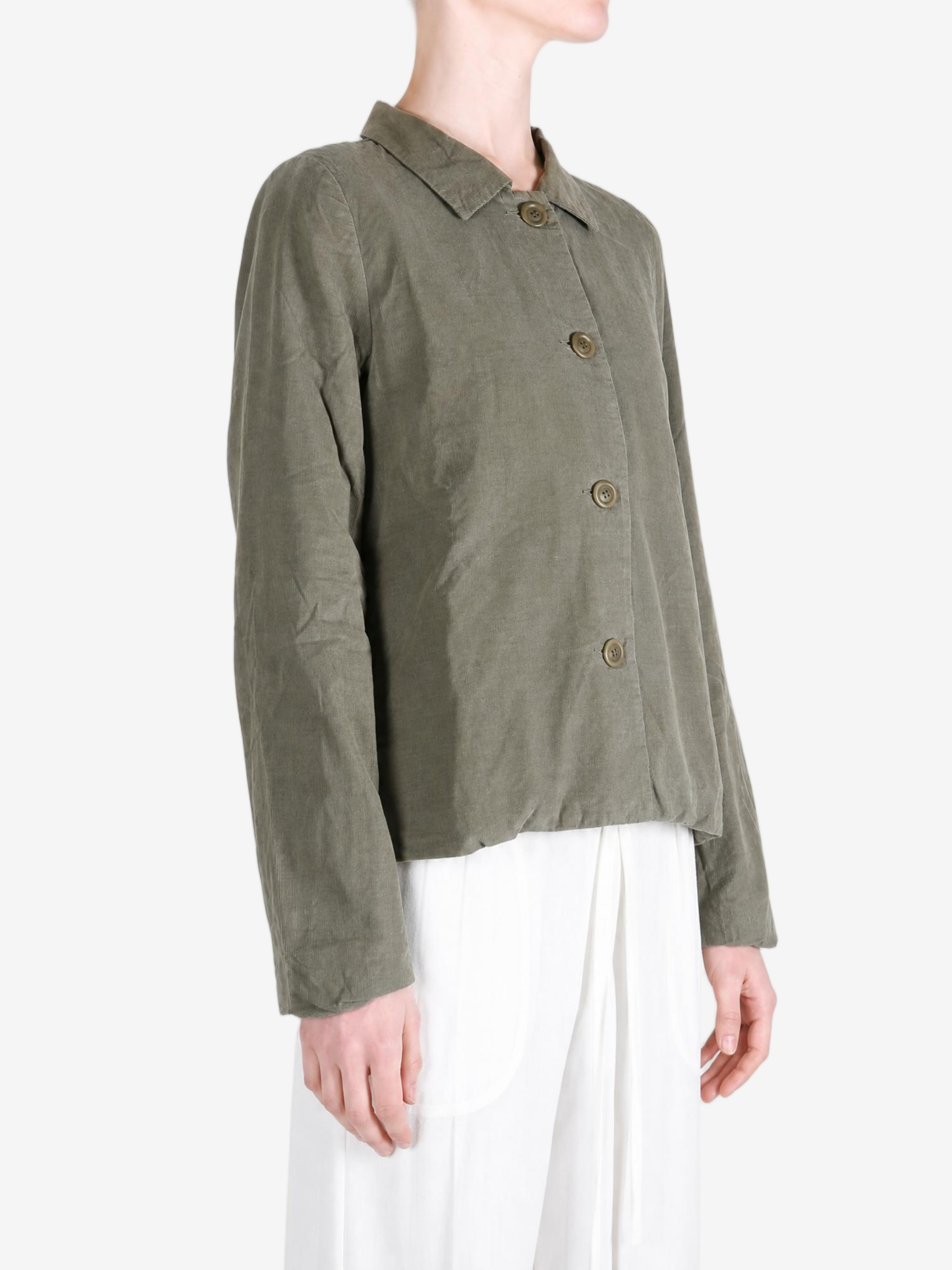 Green jacket worn by a person, showing the jacket fit
