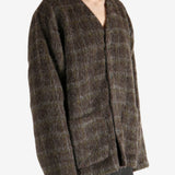 Brown knitwear worn by a person, showing the knitwear's fit