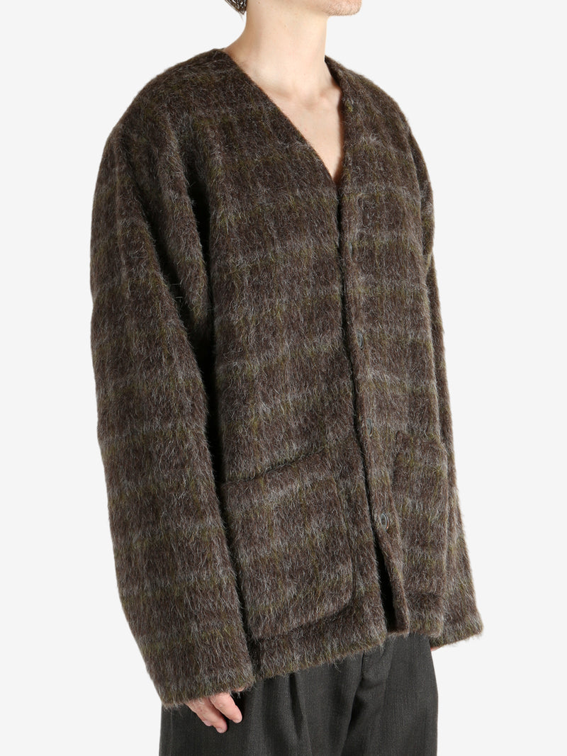 Brown knitwear worn by a person, showing the knitwear's fit