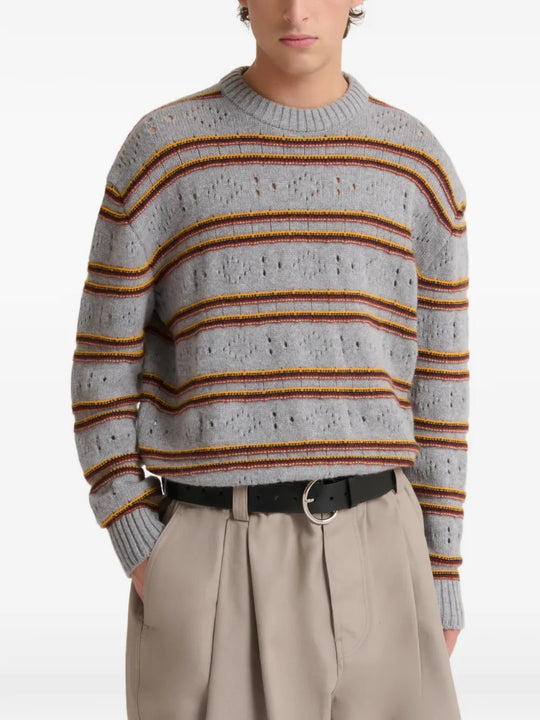 Grey knitwear worn by a person, showing the knitwear fit