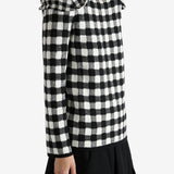 Black sweater worn by a person, showing the knitwear's fit