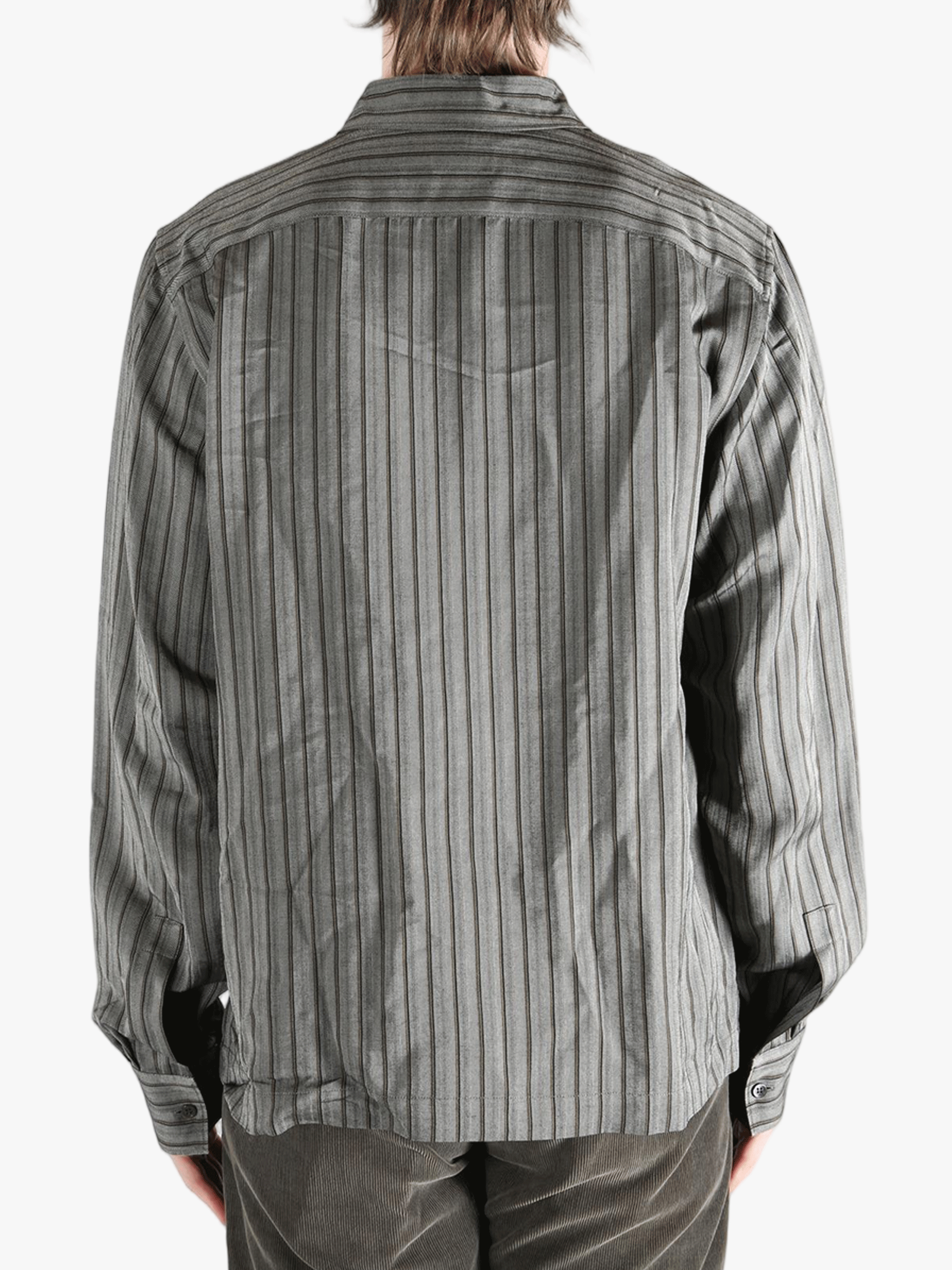 Grey shirt worn by a person, showing the shirt's fit