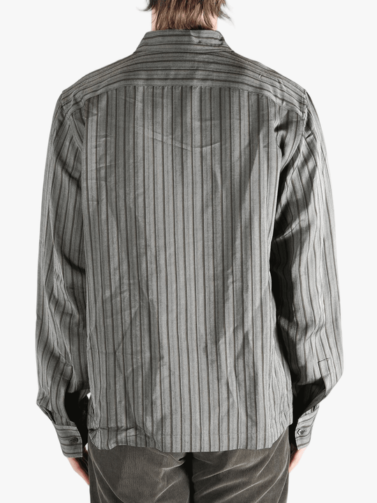 Grey shirt worn by a person, showing the shirt's fit