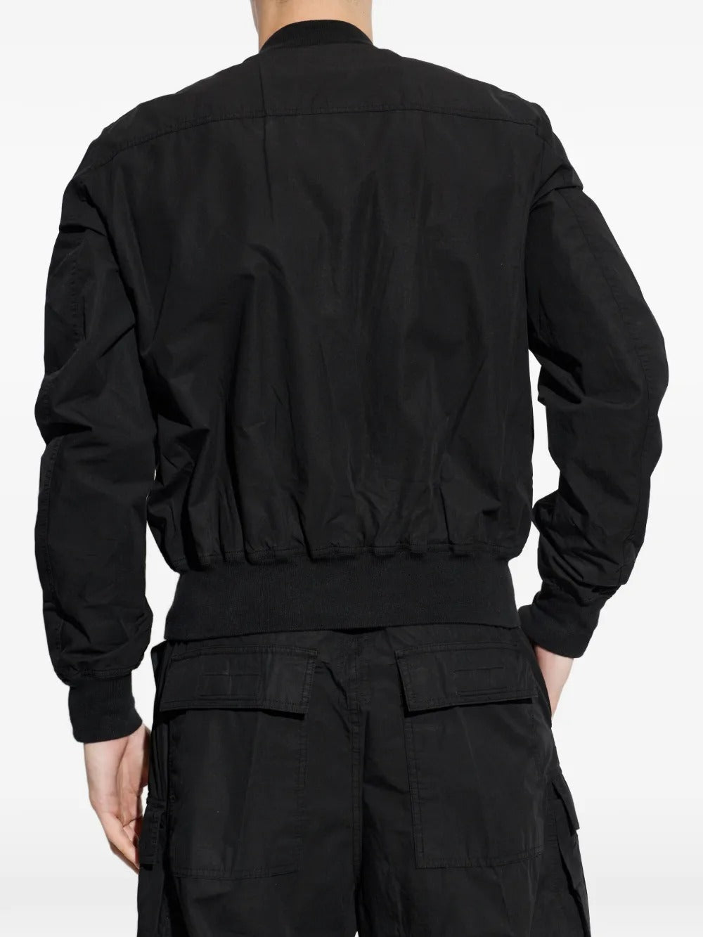 Black jacket worn by a person, showing the jacket's fit