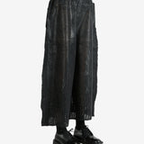 Black pants worn by a person, showing the pants' fit