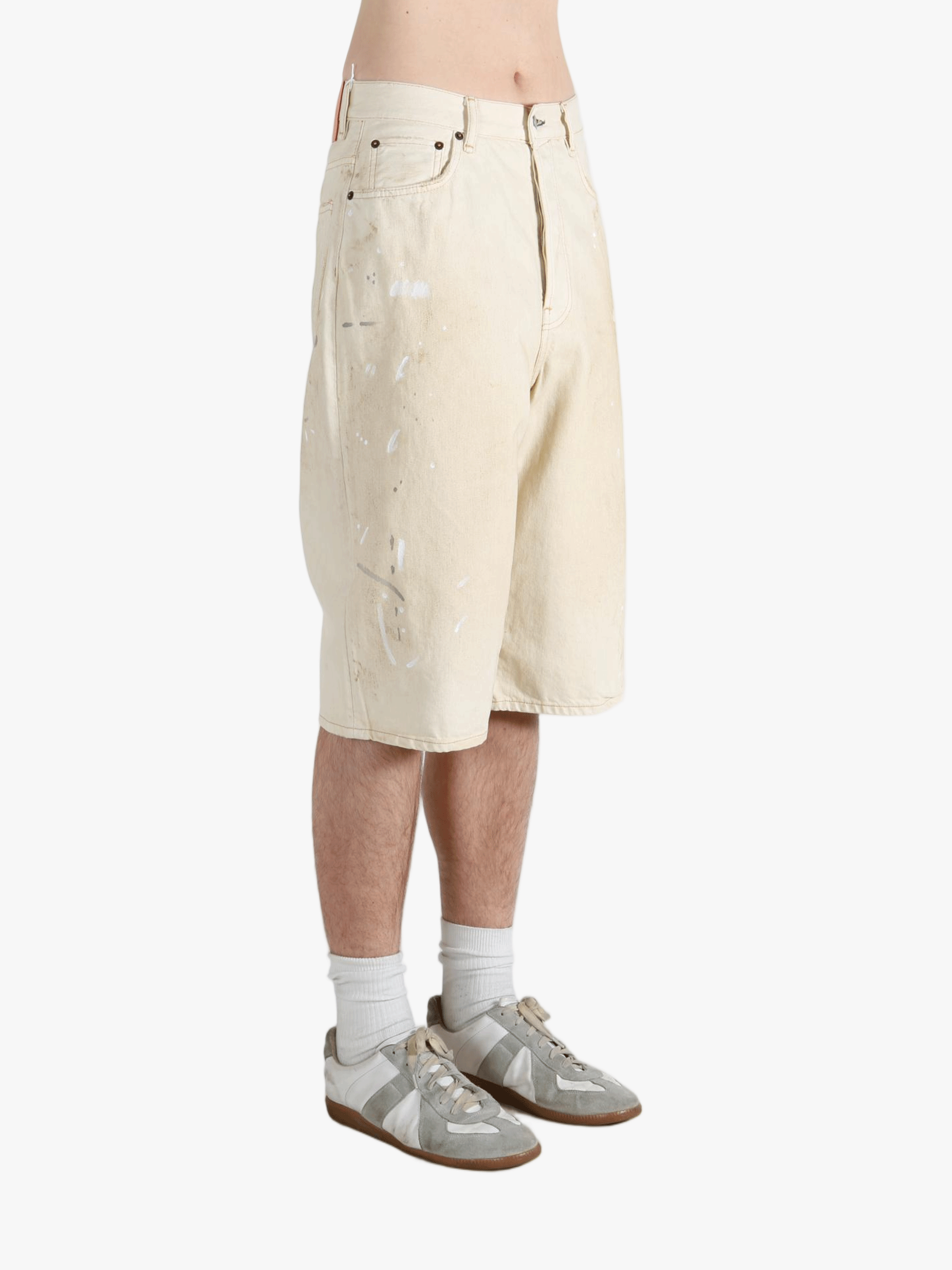 White shorts worn by a person, showing the shorts fit