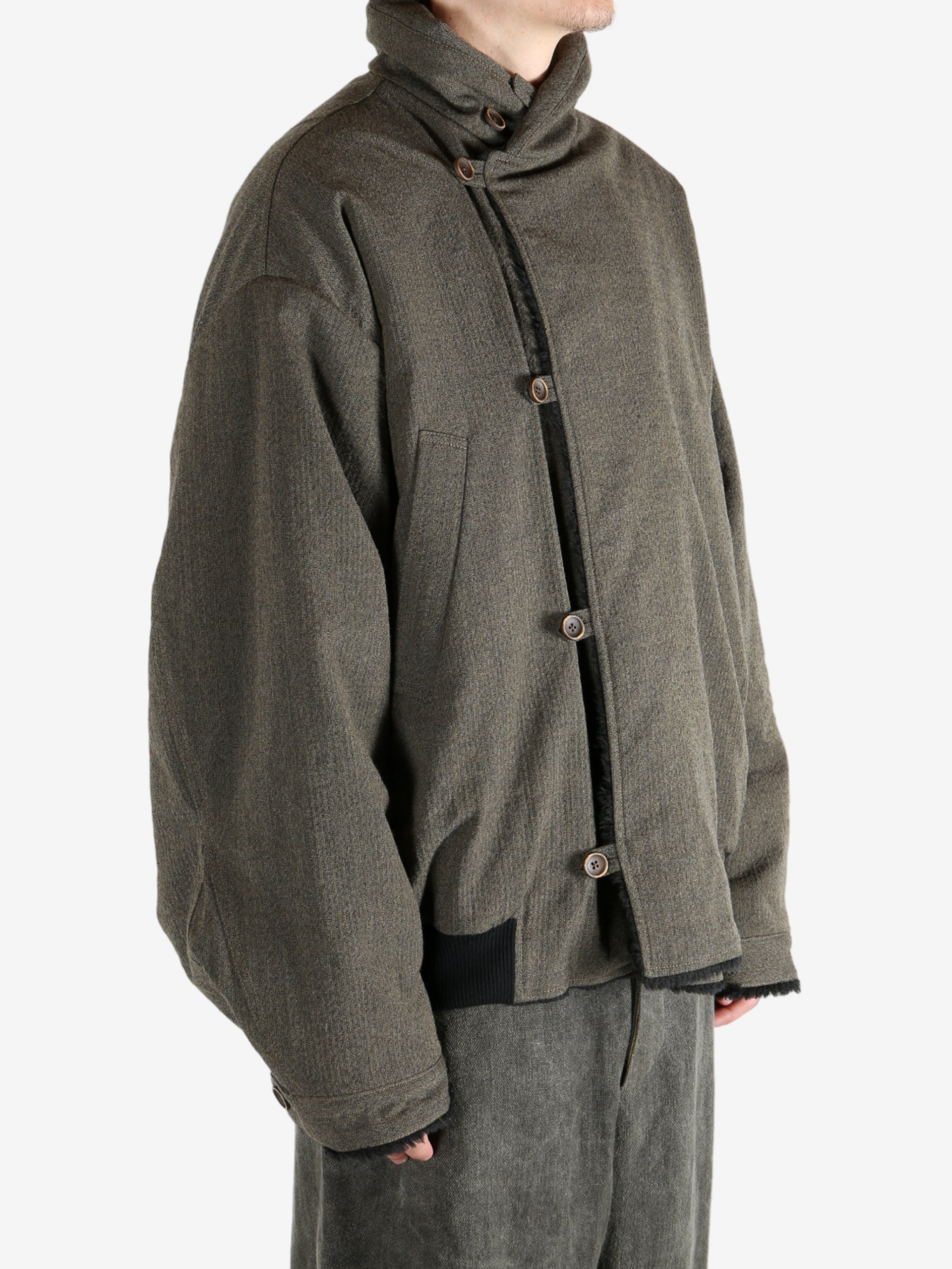 Green jacket worn by a person, showing the jacket's fit