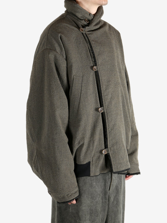 Green jacket worn by a person, showing the jacket's fit