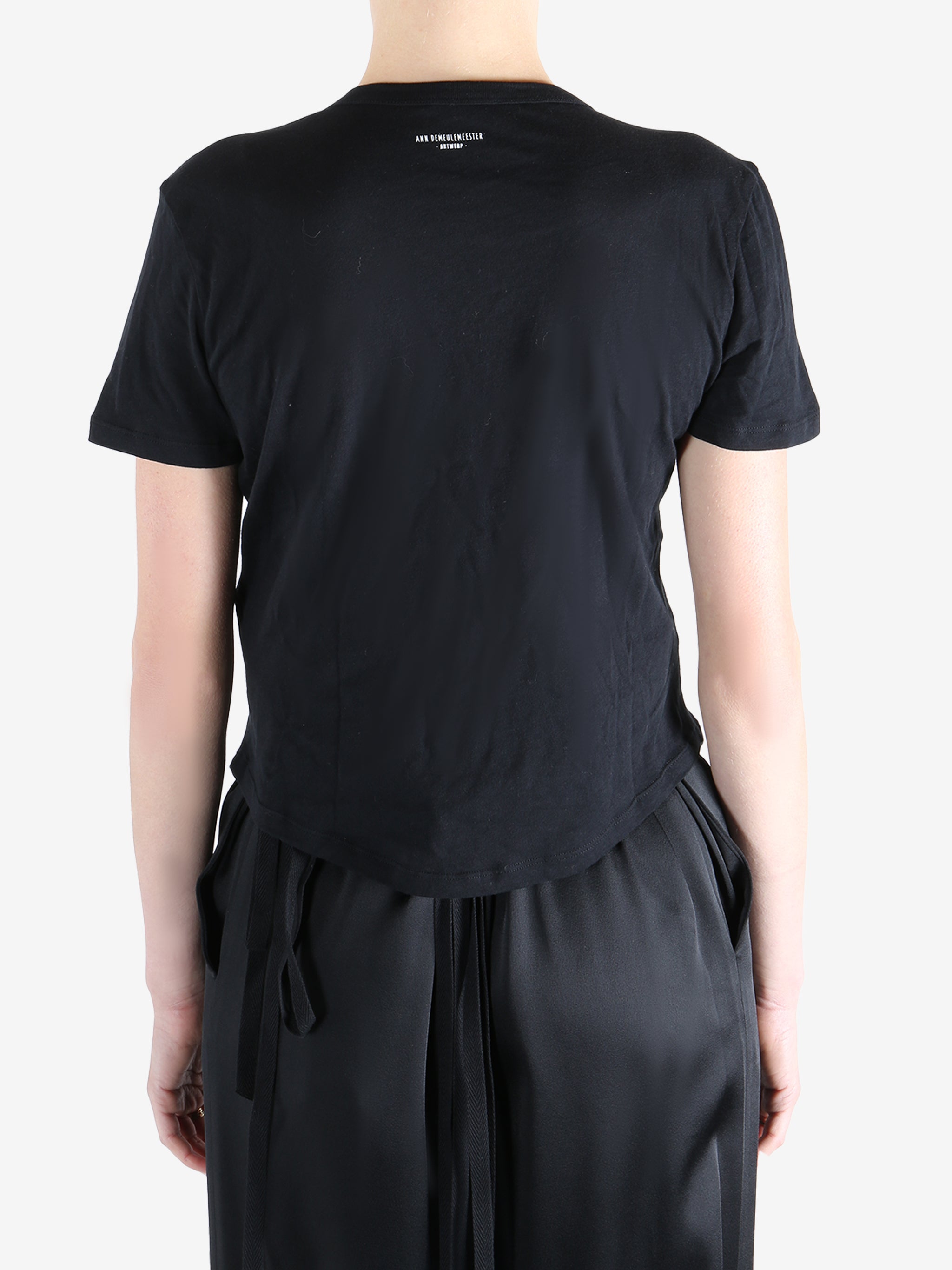 Black t-shirt worn by a person, showing the shirt's fit