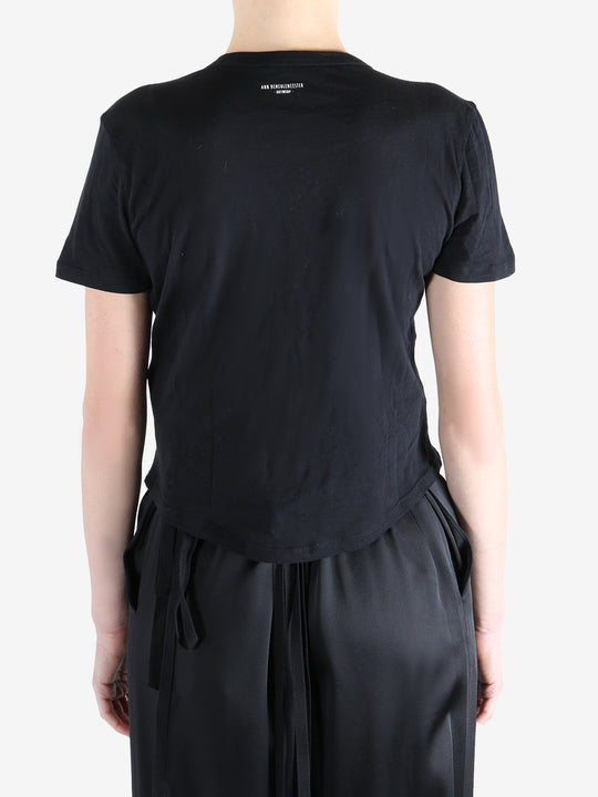 Black t-shirt worn by a person, showing the shirt's fit