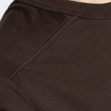 Close up of the brown t-shirt, showing texture of the cotton fabric