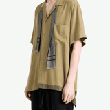 Tan shirt worn by a person, showing the shirt fit
