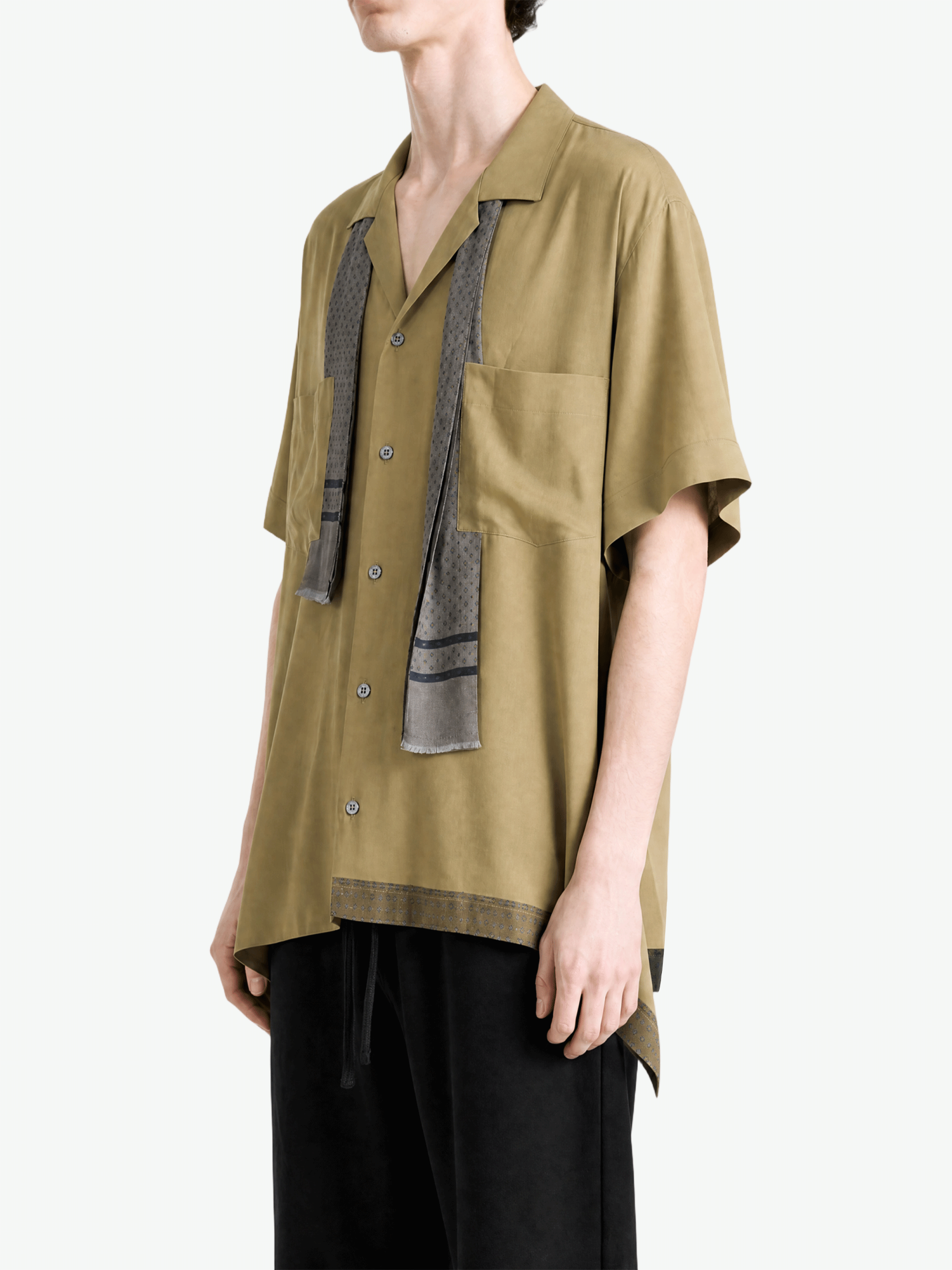 Tan shirt worn by a person, showing the shirt fit