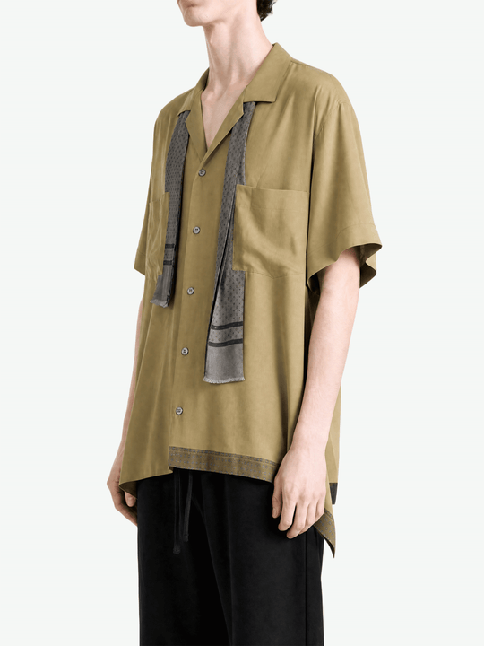 Tan shirt worn by a person, showing the shirt fit