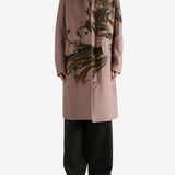 Pink coat worn by a person, showing the coat's fit