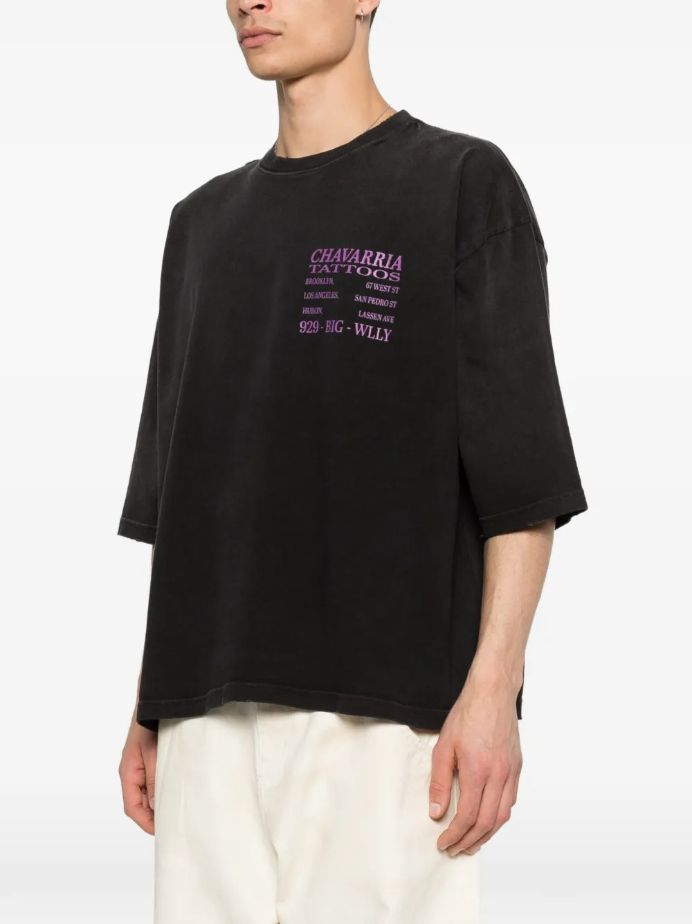 black t-shirt worn by a person, showing the t-shirt fit