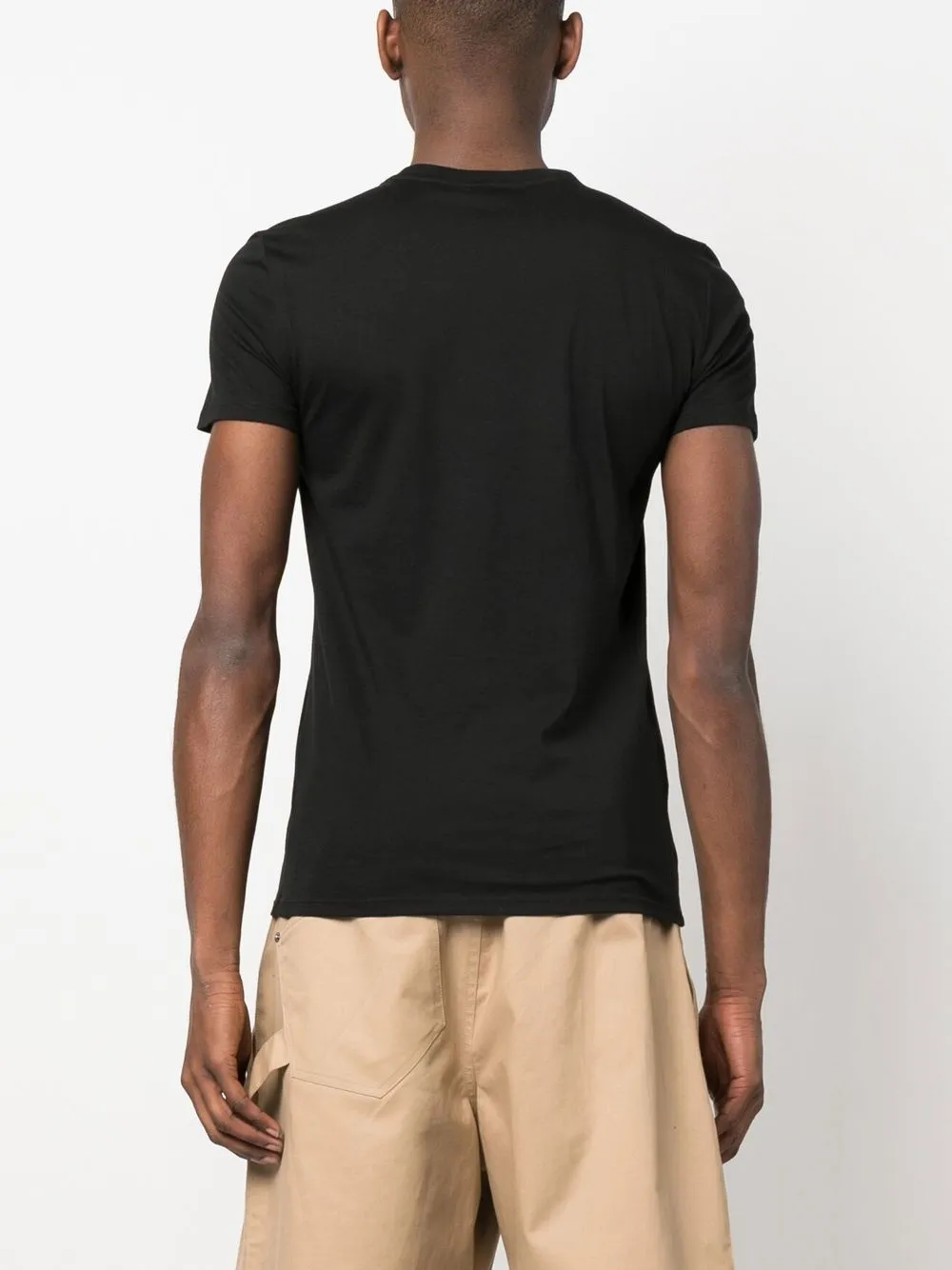 Black t-shirt worn by a person, showing the t-shirt's fit