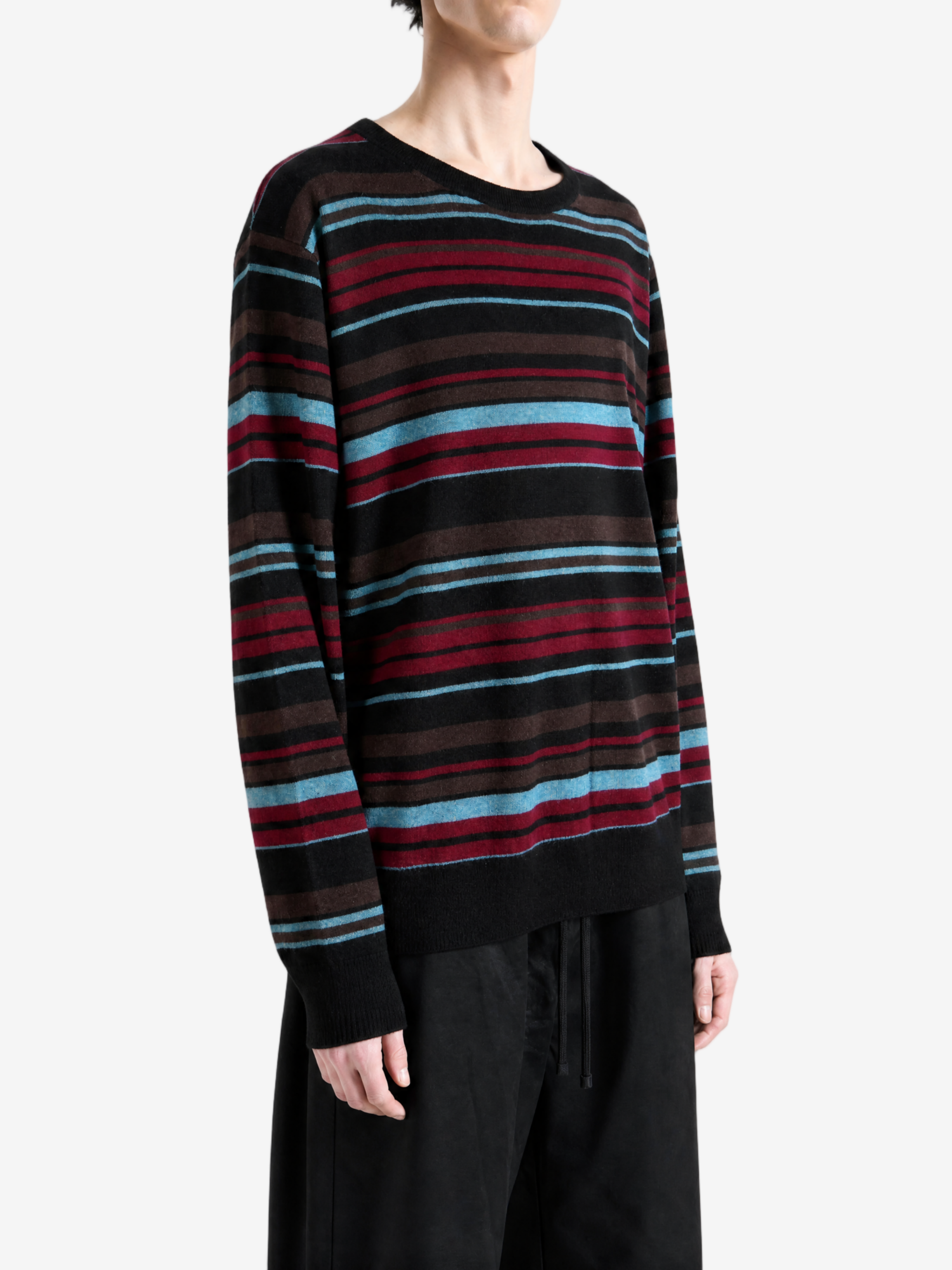 Black knitwear worn by a person, showing the knitwear fit