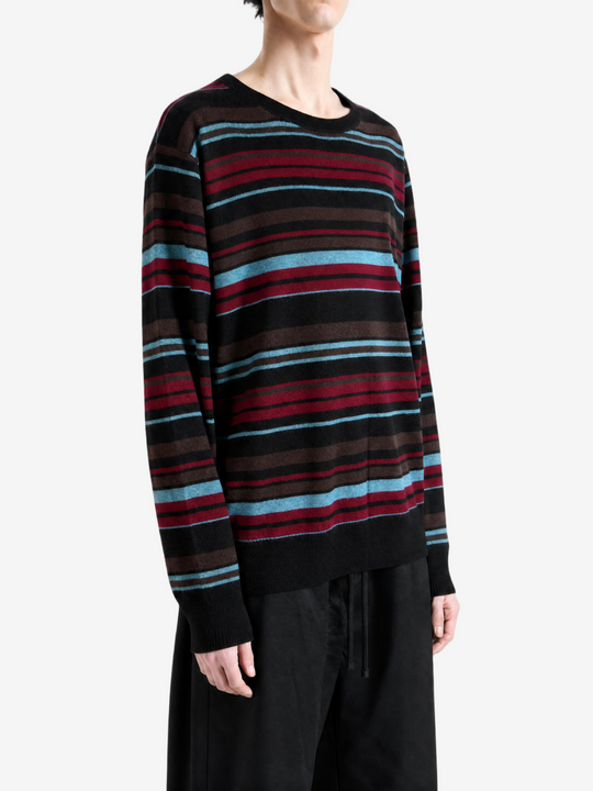 Black knitwear worn by a person, showing the knitwear fit