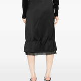 Black skirt worn by a person, showing the skirt's fit