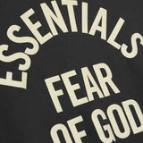 Close up of black t-shirts, showing texture of the cotton fabric
