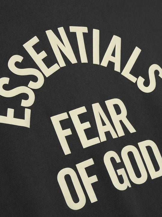 Close up of black t-shirts, showing texture of the cotton fabric