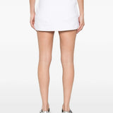 White skirt worn by a person, showing the skirt's fit