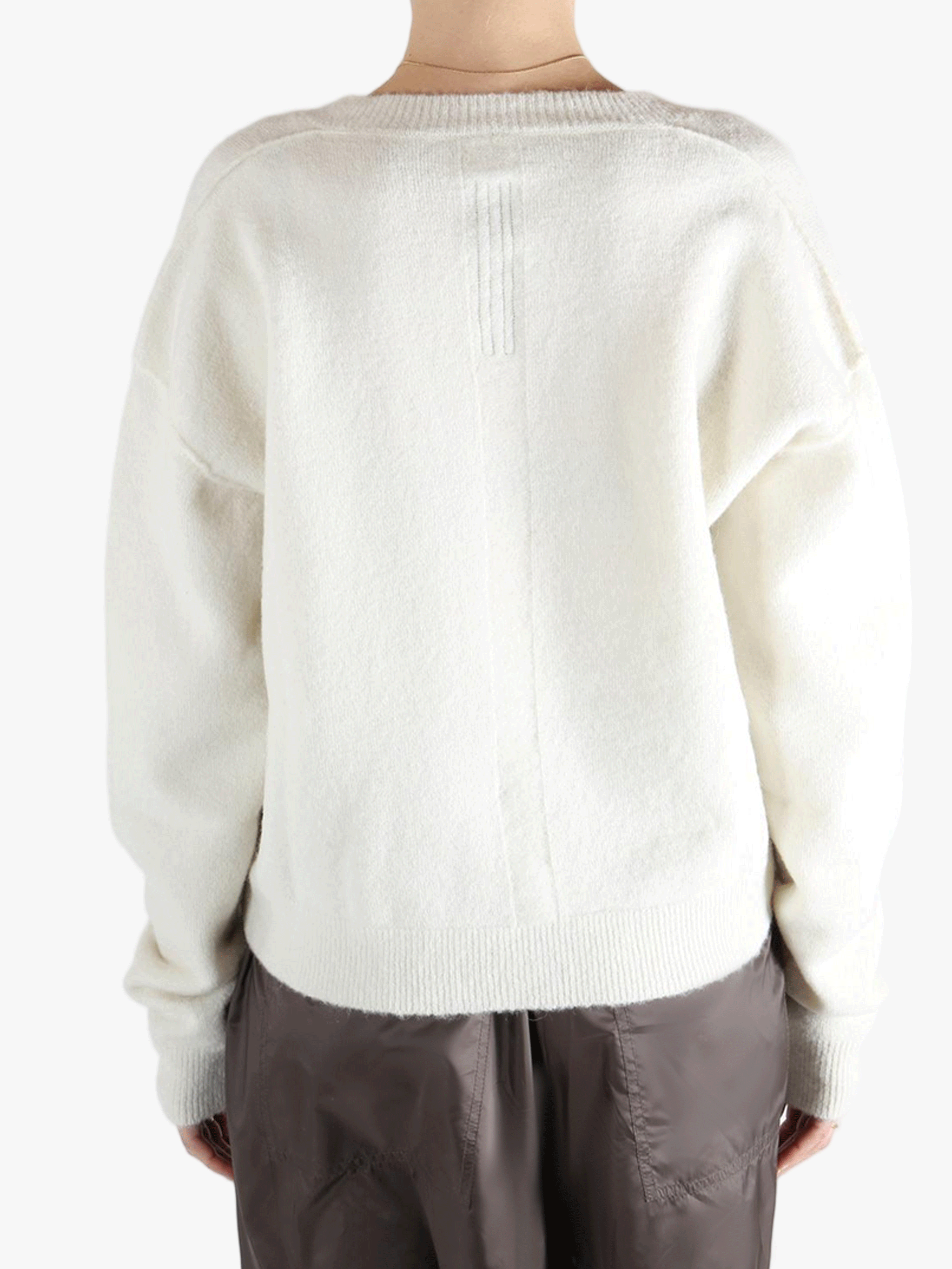 White sweater worn by a person, showing the sweater fit