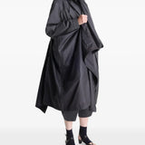 Black coat worn by a person, showing the coat's fit