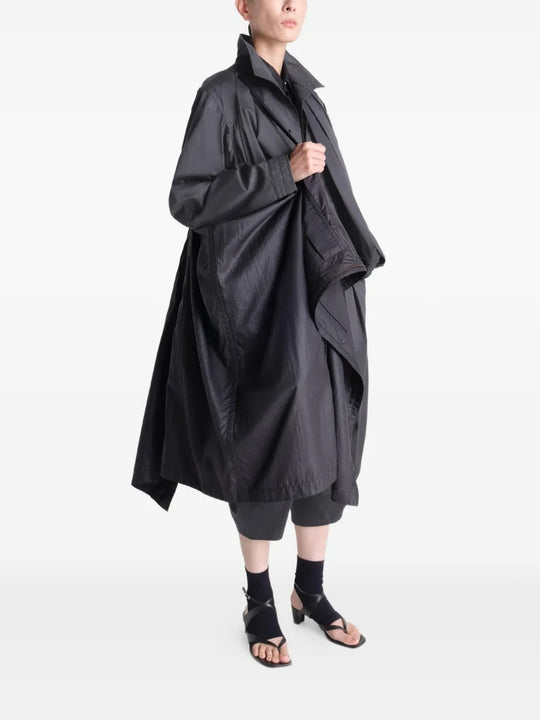 Black coat worn by a person, showing the coat's fit