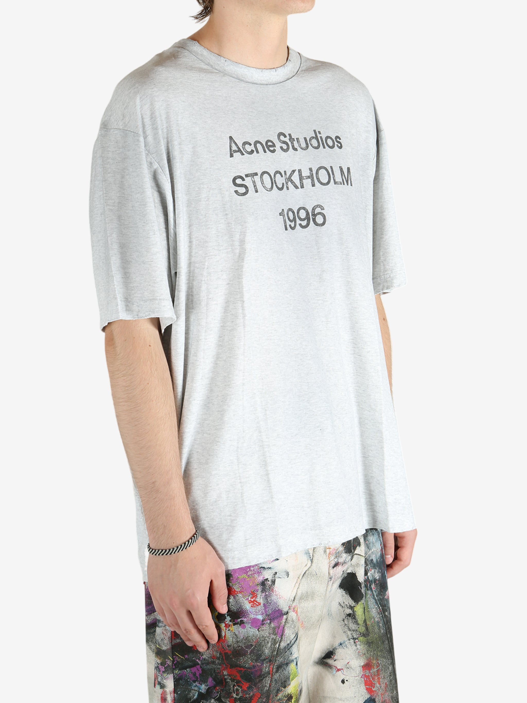 Grey t-shirt worn by a person, showing the shirt's fit