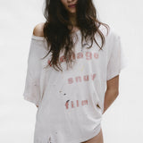 White t-shirt worn by a person, showing the shirt's fit