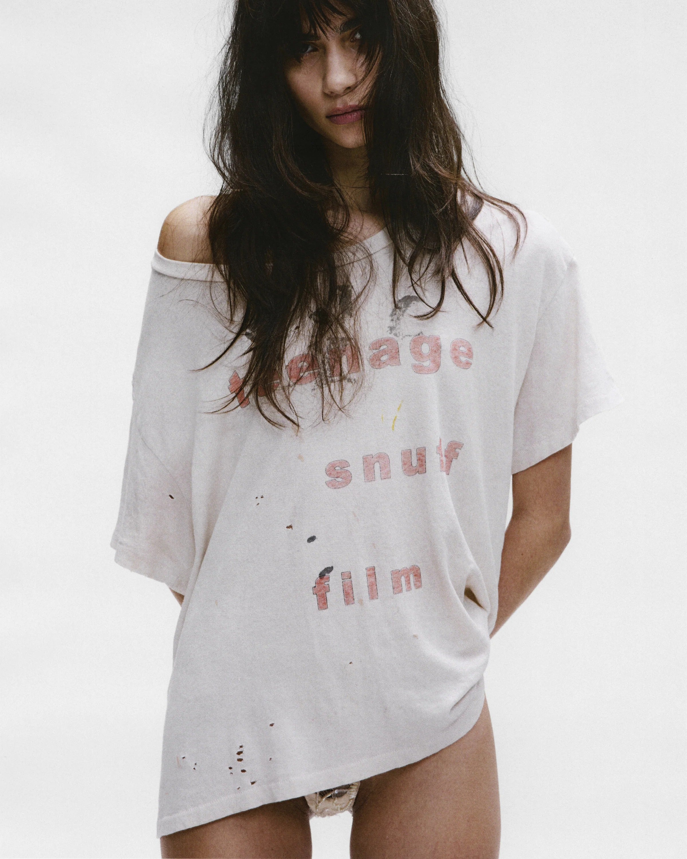 White t-shirt worn by a person, showing the shirt's fit