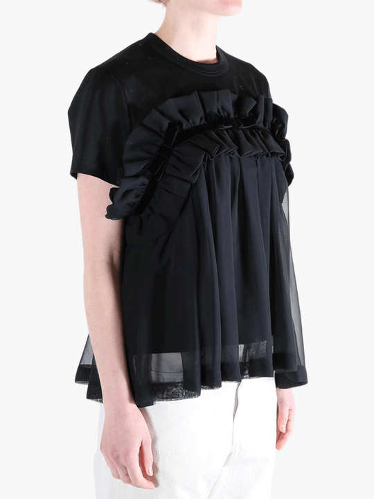 Black t-shirts worn by a person, showing the t-shirts fit