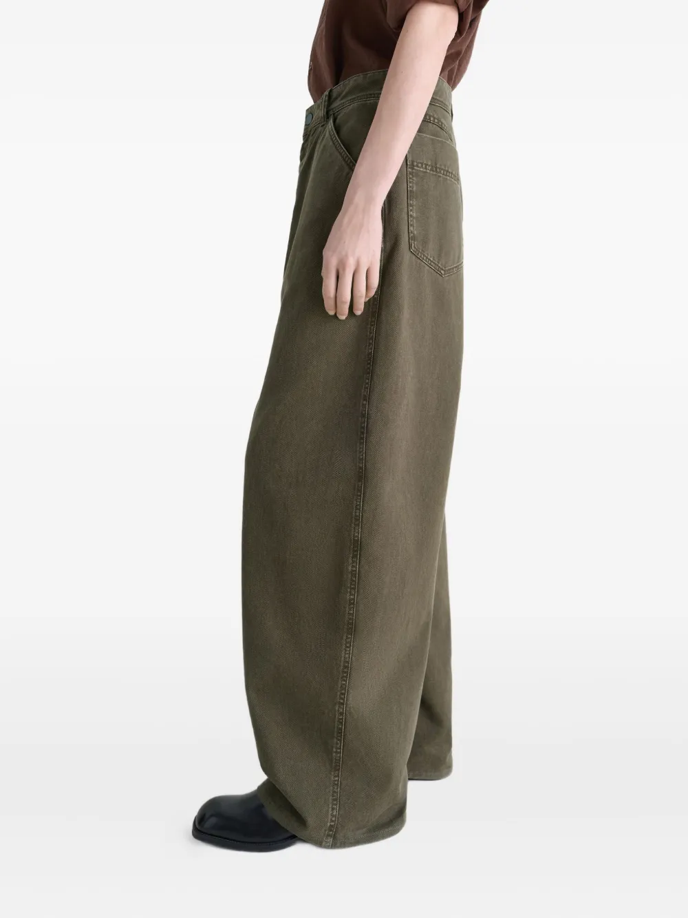 Brown pants worn by a person, showing the pants fit