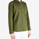 Green shirt worn by a person, showing the shirt fit