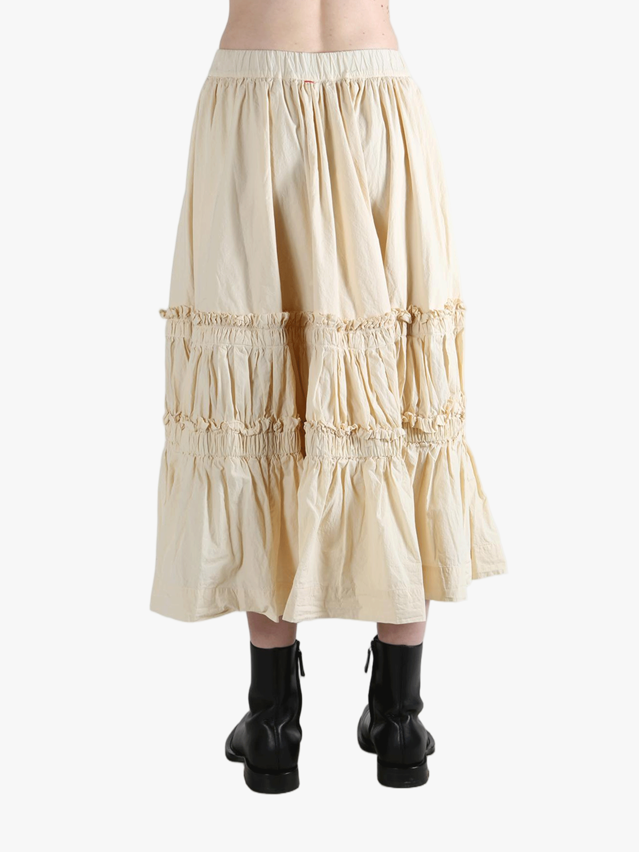 Beige tiered skirt worn by a person, showing the skirt fit