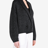 Black knitwear worn by a person, showing the knitwear fit