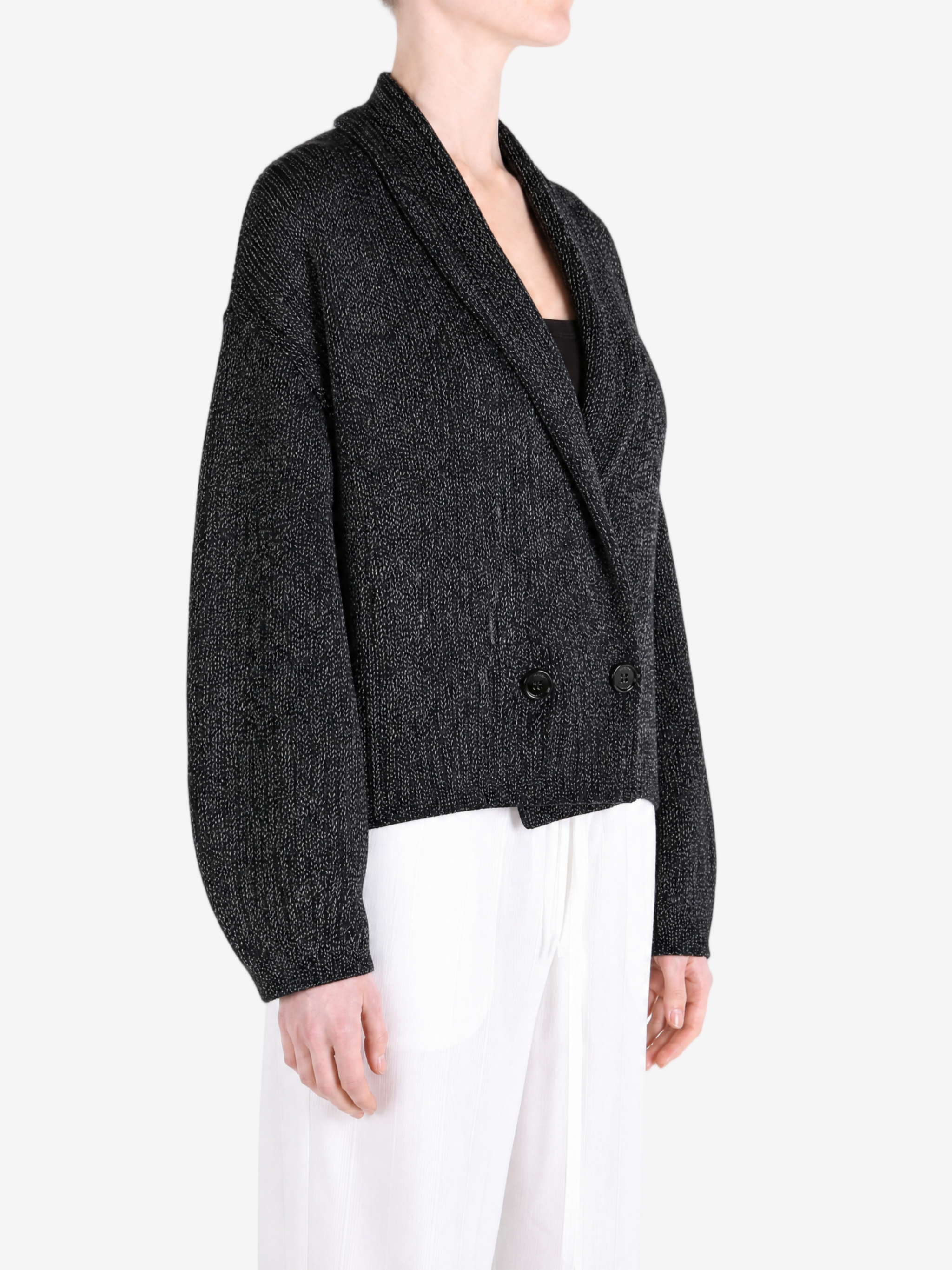 Black knitwear worn by a person, showing the knitwear fit