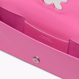 Close up of pink bag, showing texture of the leather fabric