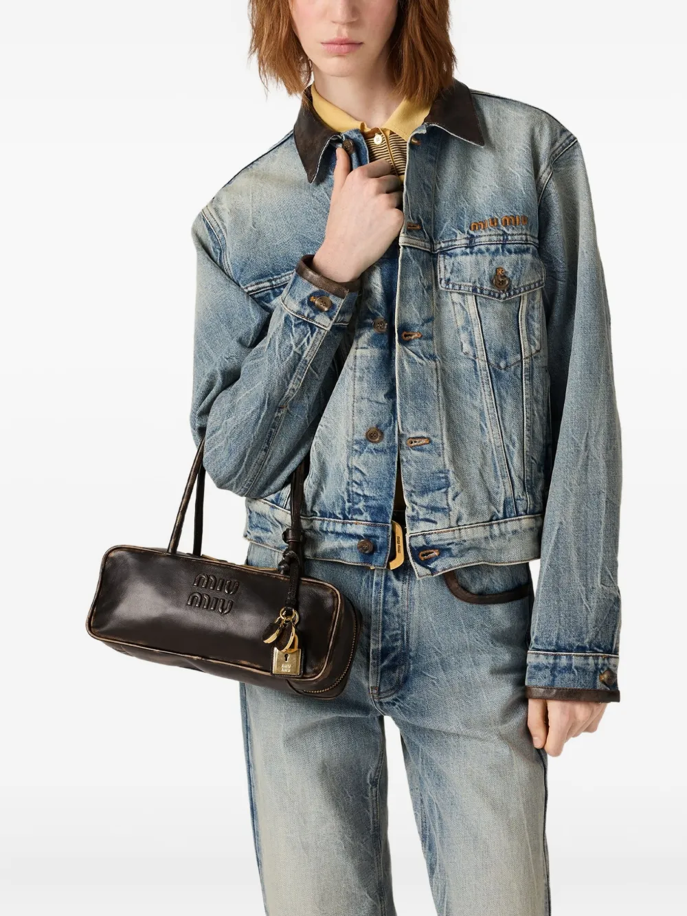 Brown handbag worn by a person, showing the handbag fit