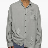 Grey shirts worn by a person, showing the shirts fit