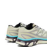 Close up of tan sneakers, showing texture of the polyester fabric